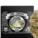 Cannabis bud beside Cure Company OG packaging